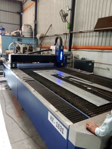 CNC laser cutting machine cutting sign parts in the ALFA Signage workshop