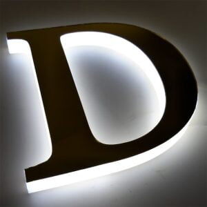 Halo-lit letter D casting a soft white glow onto the wall behind it, made by ALFA Signage